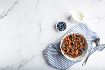 Homemade granola, muesli with pieces of dark chocolate, nuts and blueberries