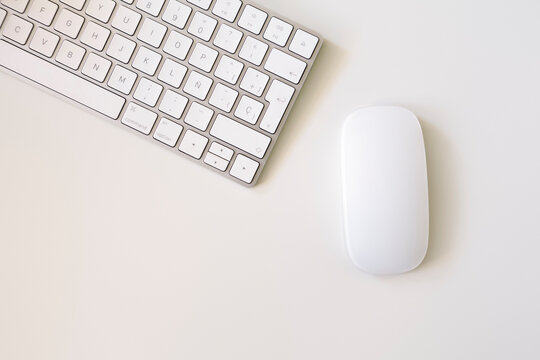 minimalistic top view of white keyboard and mouse with white background