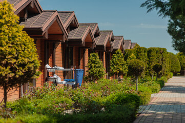 a maid trolley for cleaning rooms in a country hotel is near the bungalow