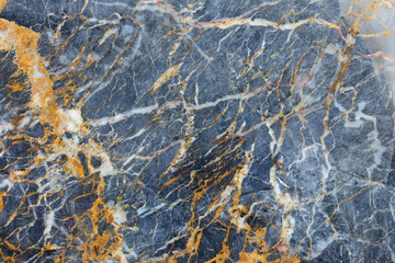 Yellow and white patterned natural of dark gray marble (Gold Russia) texture background for industrial design.