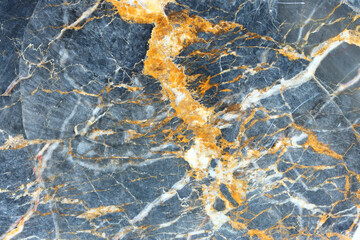 Yellow and white patterned structure of dark gray marble (Gold Russia) texture background for interior design.