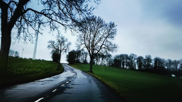 Driving country road in the rain. Travel background, 4K