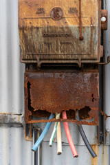 old rusty electrical box of side on abandoned warehouse
