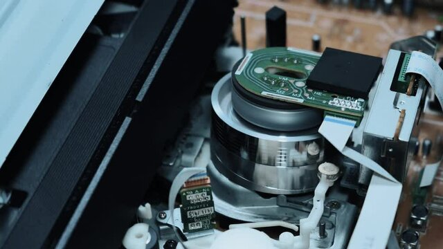 A cassette tape is inserted into the VCR, and the video from inside is played. Close-up. the film is stretched on the coil