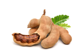 Pile of tamarind fruits with green leaves isolated on white background. - obrazy, fototapety, plakaty