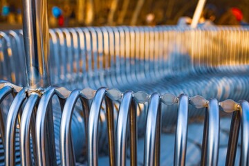 Close-up street bench metal pipes arranged parallel