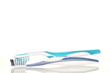 Two toothbrushes, close-up, isolated on white.