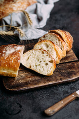 Homemade Ciabatta Bread. Sliced ​​bread slices on a wooden board. Bread with pesto sauce