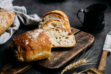 Homemade Ciabatta Bread. Sliced ​​bread slices on a wooden board. Bread with pesto sauce