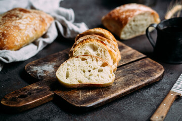 Homemade Ciabatta Bread. Sliced ​​bread slices on a wooden board. Bread with pesto sauce