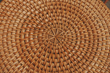 Background texture or pattern from a basket, woven with natural straw-colored reeds. Abstract decorative wooden textured basket weaving. Basket texture background, closeup