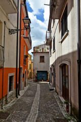 Fototapeta na wymiar Nusco, Italy, May 8, 2021. A small street among the picturesque houses of a medieval village in the province of Avellino.