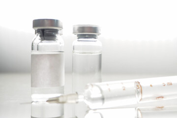 ampoules with Covid-19 vaccine on a laboratory bench. to fight the coronavirus, sars-cov-2 pandemic. Vaccine and syringe injection. It use for prevention, immunization and treatment