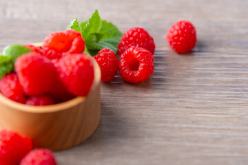 Fresh raspberries on wooden board.

