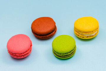 multicolored macaron cakes on a blue paper background