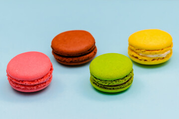 color macaron cakes on a blue paper background