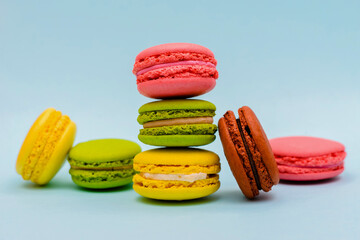 multicolored macaron cakes on a blue paper background