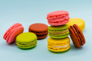 multicolored macaron cakes on a blue paper background
