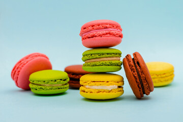 multicolored macaron cakes on a blue paper background