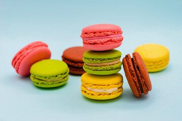 multicolored macaron cakes on a blue paper background