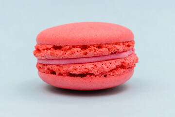 pink macaron cake on a blue paper background