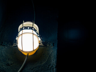 Old-fashioned street lamp at night. Mystical atmosphere, light in the bunker. Light and dark