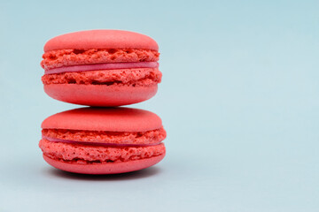 two pink macaron cakes on a blue background