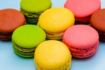 Fototapeta na wymiar several color macaron cakes on a blue background