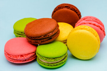 several color macaron cakes on a blue background