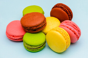 several color macaron cakes on a blue background