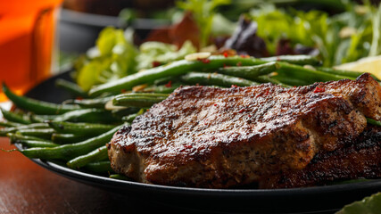 Grilled pork loin chops served with French green beans salad and beer