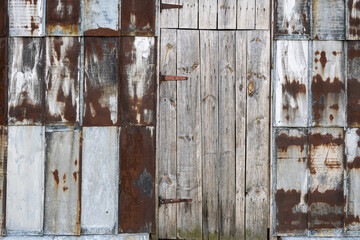 texture of old rusty metal sheets, background, wall, pattern, wooden door in the wall of metal