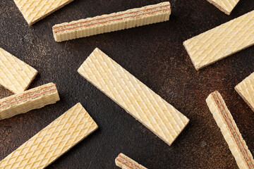 Tasty wafer biscuits with chocolate on rustic table