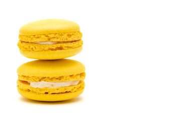 two yellow macaron cakes on a white background