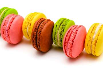 several multicolored macaron cakes on a white background