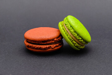 two color macaron cakes on a black background