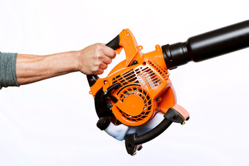 Close up hand holding a Garden blower isolated on white background. Worker with a leaf blower. Leaf...
