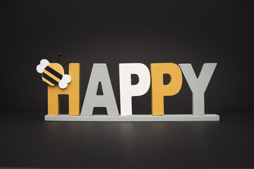 Be Happy. Concept of happiness. Creative home decoration isolated on dark background.