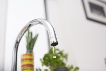 Kitchen tap isolated on bright background. Water saving solutions.