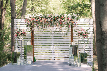 Wedding ceremony. Very beautiful and stylish wedding arch, decorated with various fresh flowers,...