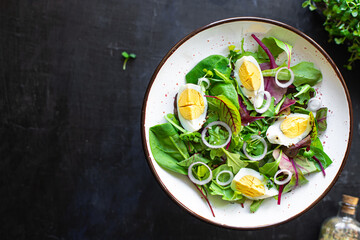 egg vegetables salad green leaves mix spinach, arugula, lettuce on the table wholesome food healthy meal snack copy space food background rustic. top view keto or paleo diet veggie or vegetarian
