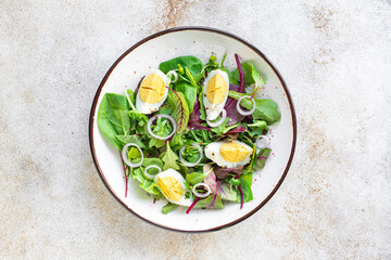 egg vegetables salad green leaves mix spinach, arugula, lettuce on the table wholesome food healthy meal snack copy space food background rustic. top view keto or paleo diet veggie or vegetarian