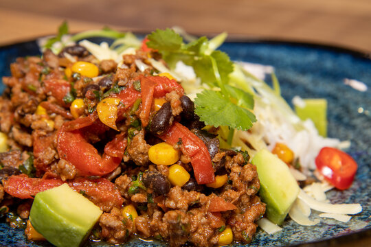 A Delicious Plate Of A Burrito Fillings With Salad On A Wooden Kitchen Restaurant Table