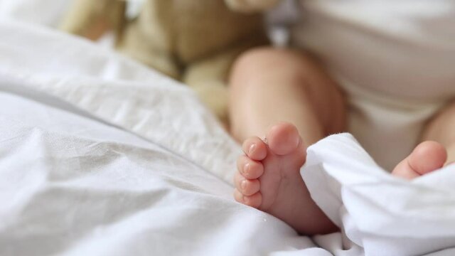 baby's feet to the bed close-up