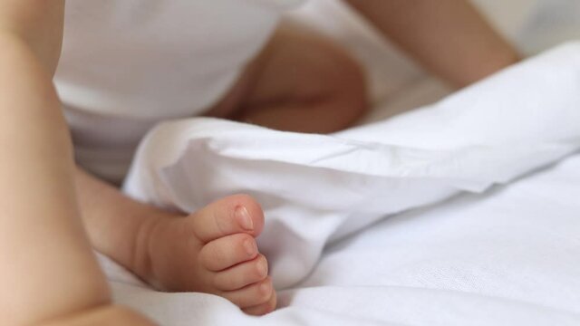 baby's feet to the bed close-up