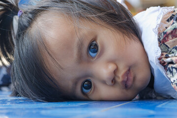 Portrait of an asian baby girl Lying on the floor at home