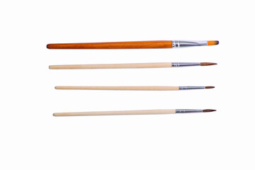 Paint brushes isolated on white background. Flat lay.