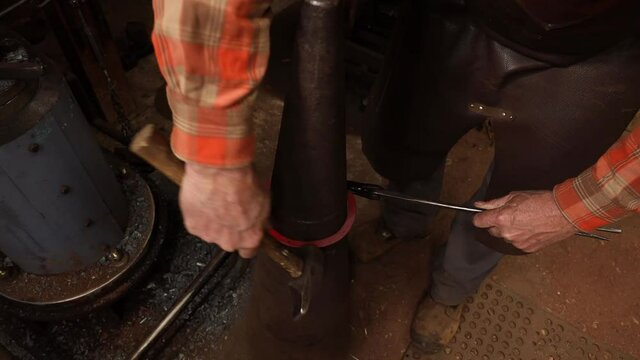 Blacksmith forging ring on cone mandrel