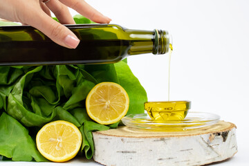 Closeup shot of olive oil being poured into a plate near salad ingredients © Tatjana Marjanović/Wirestock