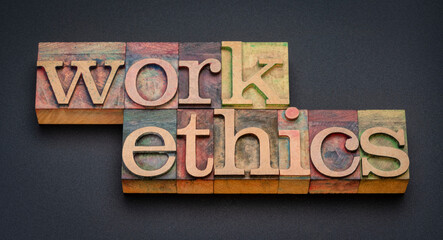 work ethics - word abstract in letterpress wood type stained by color inks against matte black...